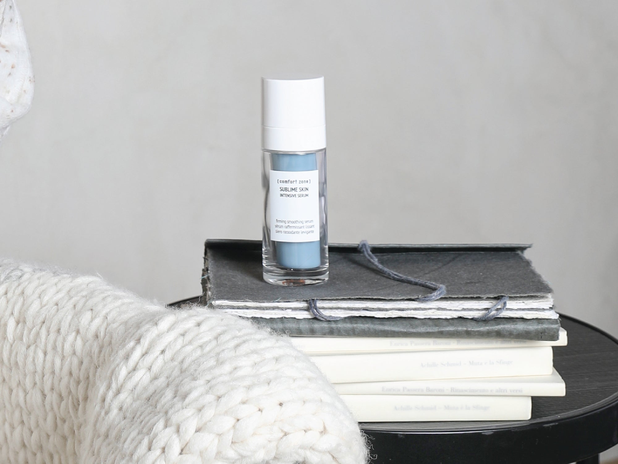 [ comfort zone ] Sublime Skin Intensive Serum on a white background next to the books