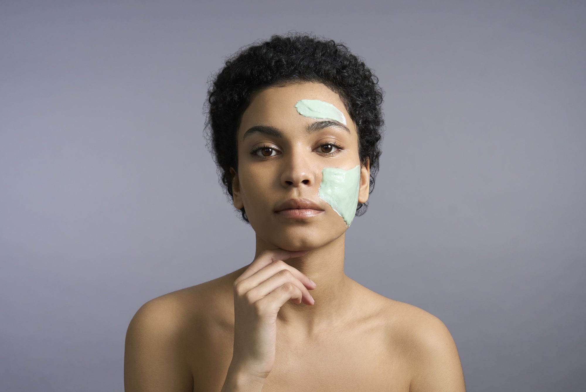woman with a face mask applied to her skin